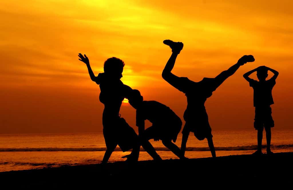 Children playing at sunset on beach
