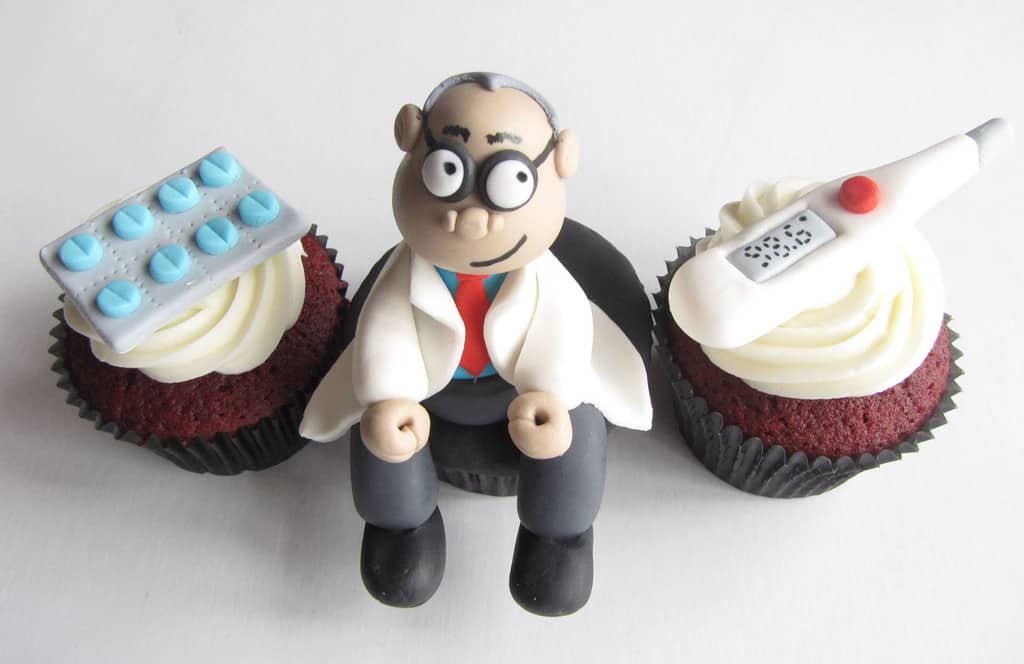 Red velvet cupcakes decorated with a doctor thermometer medicine