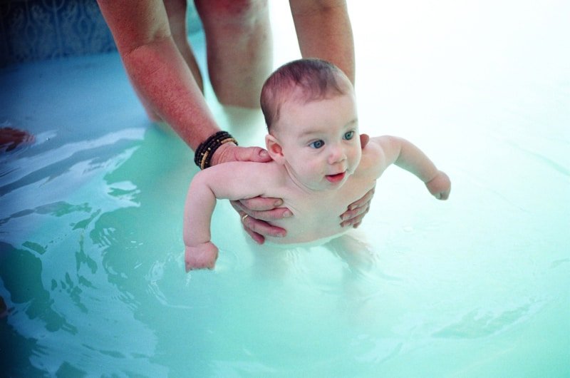 Infant in pool with dad