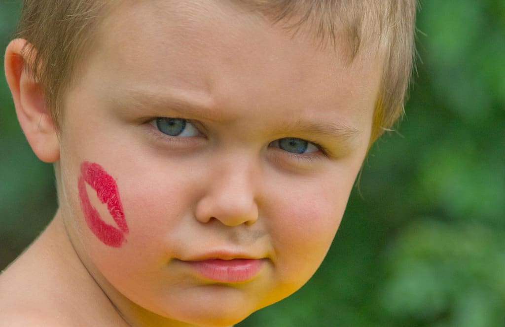 Boy with lipstick kiss