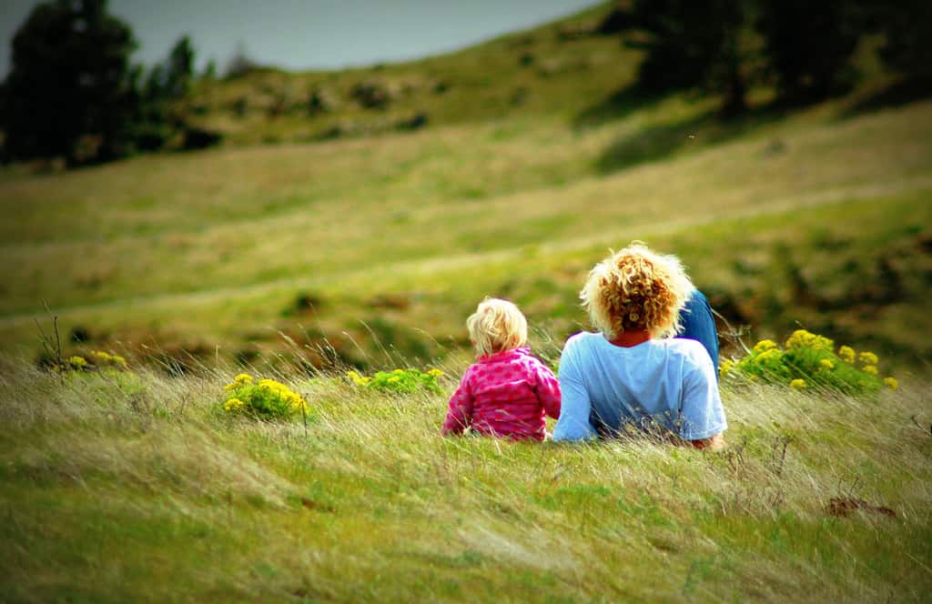 Dad and Daughter Relaxing on Hillside
