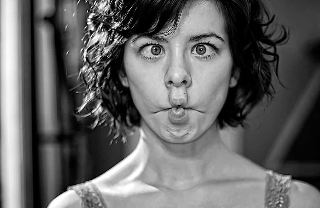 Woman making puckered lips face in B&W