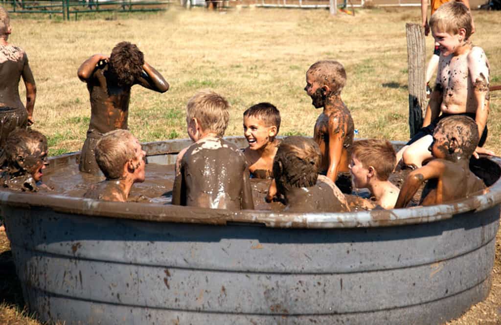 Outdoor mud tub filled with boys