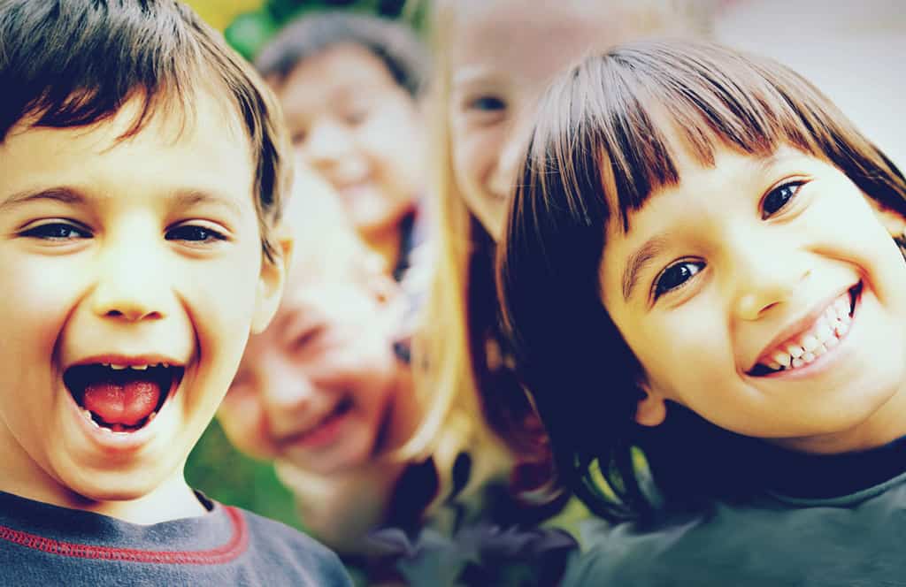 Close-up of children showing their teeth and smiling